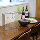 Hanauta stainless steel kitchen rack hanger on a dining table, used for drying wine glasses, stylish kitchen organiser for modern home decor.