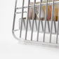 Close-up of Hanauta stainless steel kitchen rack stand showing non-slip base and drainage tray for safe, hygienic utensil organisation on countertops.