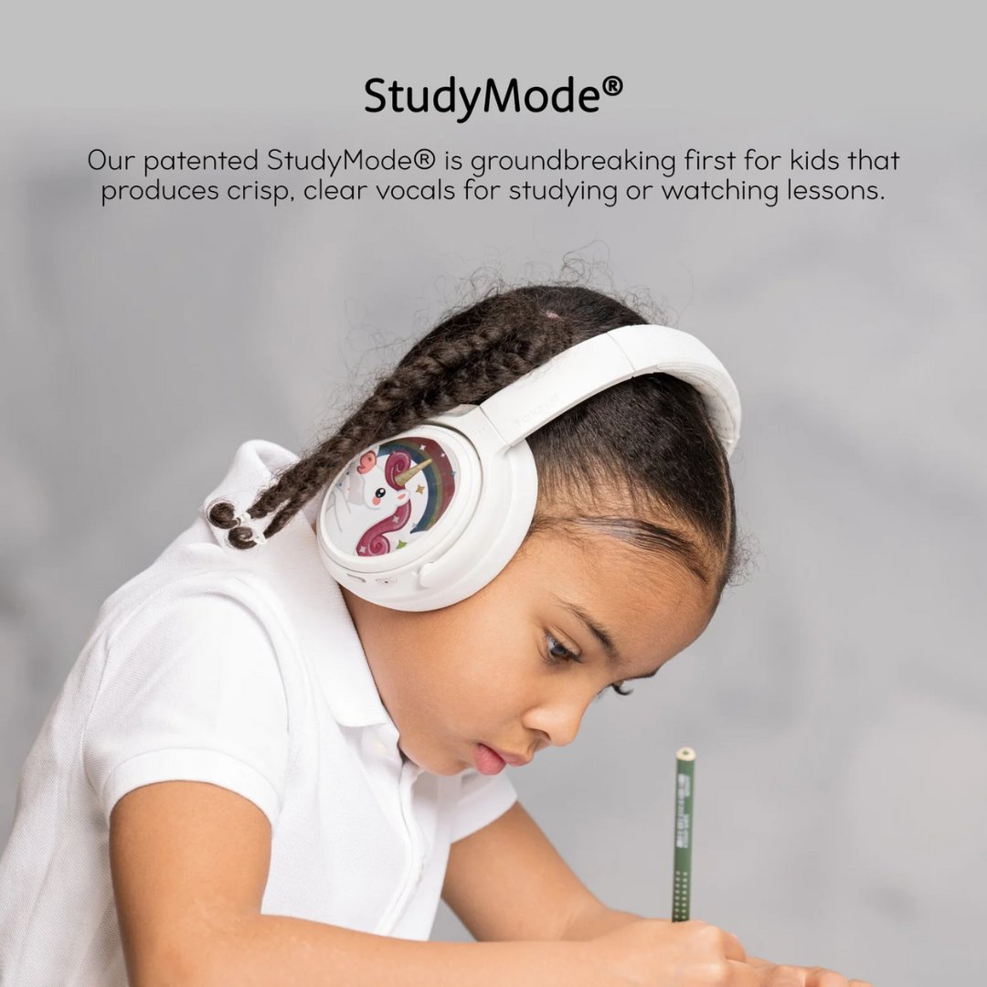 Young girl with braided hair wearing white unicorn headphones and a white polo shirt, writing with a pencil while studying; promotional text about "StudyMode" technology for kids' headphones is visible above.
