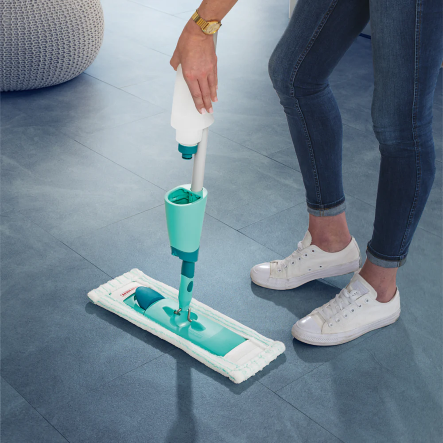Person attaching a refillable spray cartridge to the Leifheit Comfort Easy Spray XL microfiber floor mop.