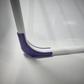 Close-up of Leifheit Pegasus 120 Solid Compact clothes drying rack with purple anti-slip feet resting securely on a bathtub surface