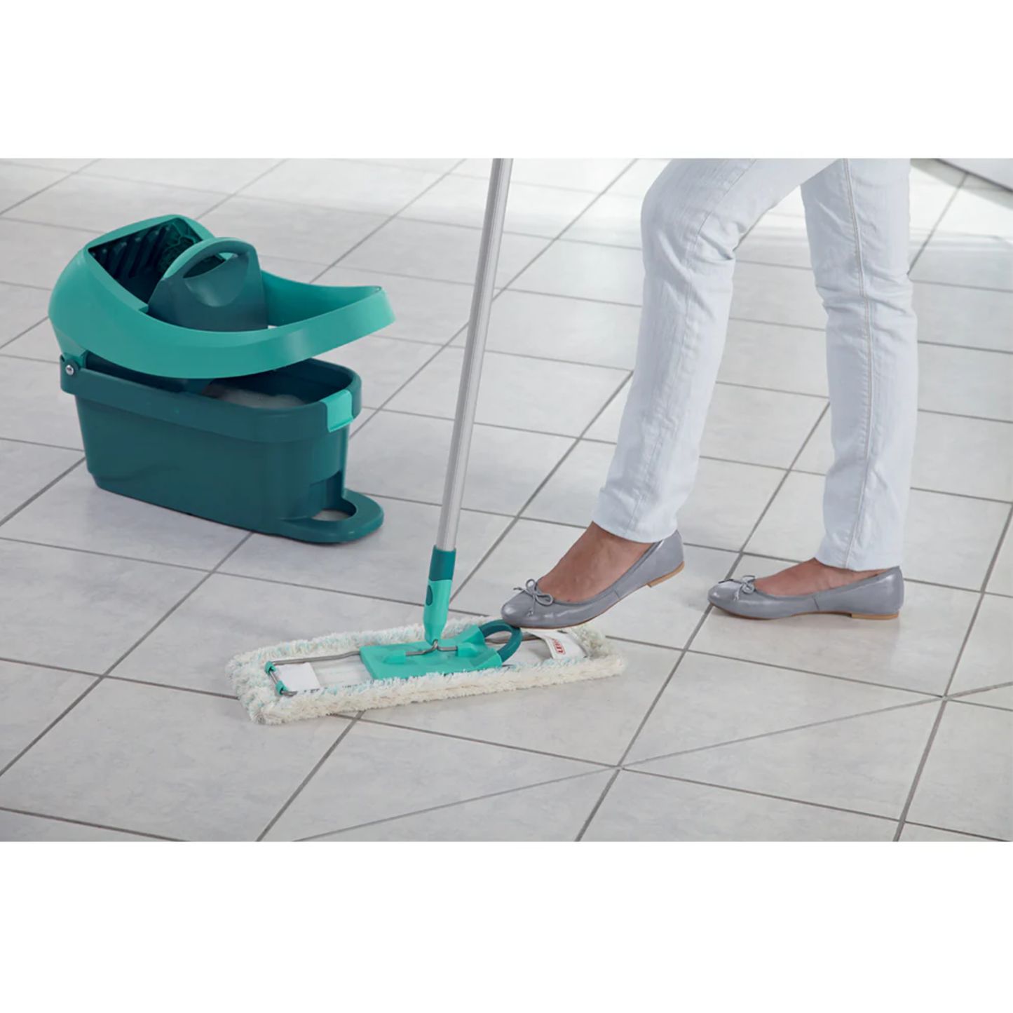Person using the Leifheit Profi System flat mop and press bucket to clean white tiled floors without bending