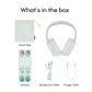 Flat lay of mint green over-ear headphones and accessories on a white background, including a matching travel bag, a sheet of animal-themed stickers, a mint BuddyLink audio cable, and a mint USB charge cable, each item labeled