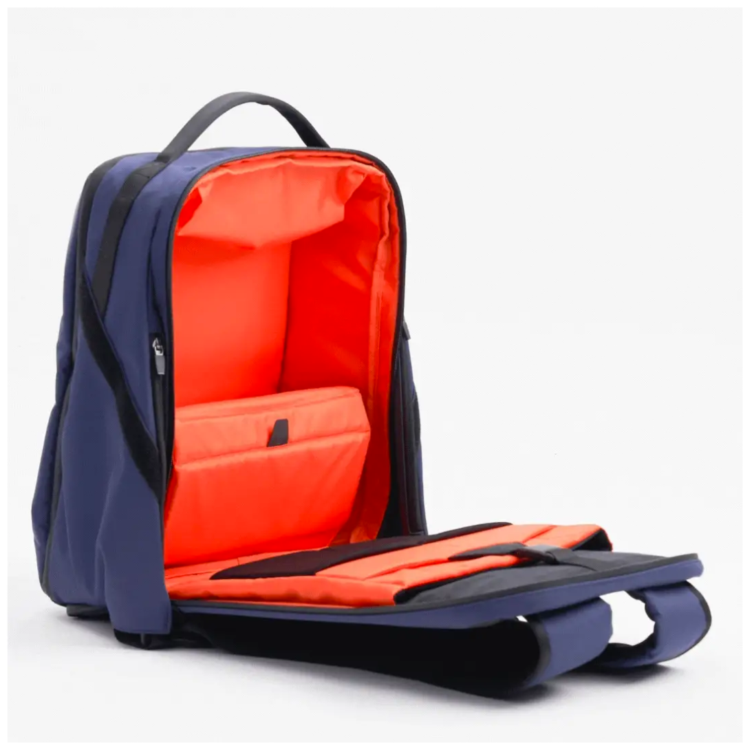 Navy backpack fully open to reveal a bright orange padded interior with a dedicated laptop compartment, designed for organized and secure storage.