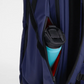 Close-up of navy blue backpack with side zipper pocket holding a turquoise water bottle.