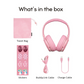 Flat lay of pink kids’ headphones and accessories on a white background, including a pink travel bag, a sheet of decorative stickers with unicorn and floral designs, a pink BuddyLink audio cable, and a pink USB charge cable, each item labeled