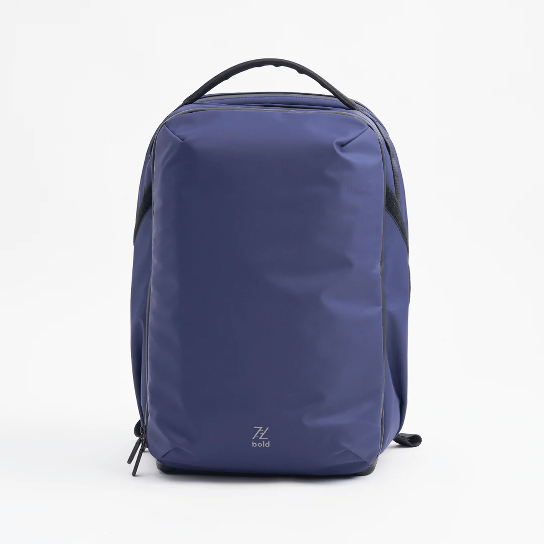 Front view of the PYX 24L Serious Travel Backpack in navy blue, featuring a sleek, water-resistant exterior and ergonomic top handle, designed for work, gym, and travel organization.