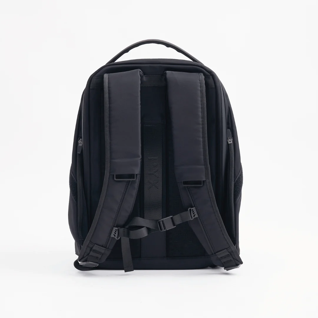 Back view of PYX black backpack showing padded shoulder straps, ergonomic back panel, and adjustable sternum strap for comfortable carrying.