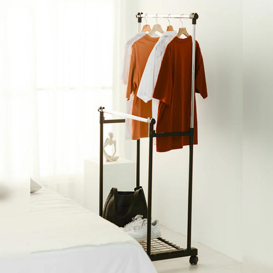 Slim double-pole clothes rack in bedroom holding t-shirts with storage shelf for bag and shoes