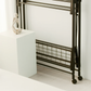 Side view of RENE Ocho foldable laundry drying rack stored upright on wheels beside a white pedestal, highlighting slim, space-saving indoor storage design