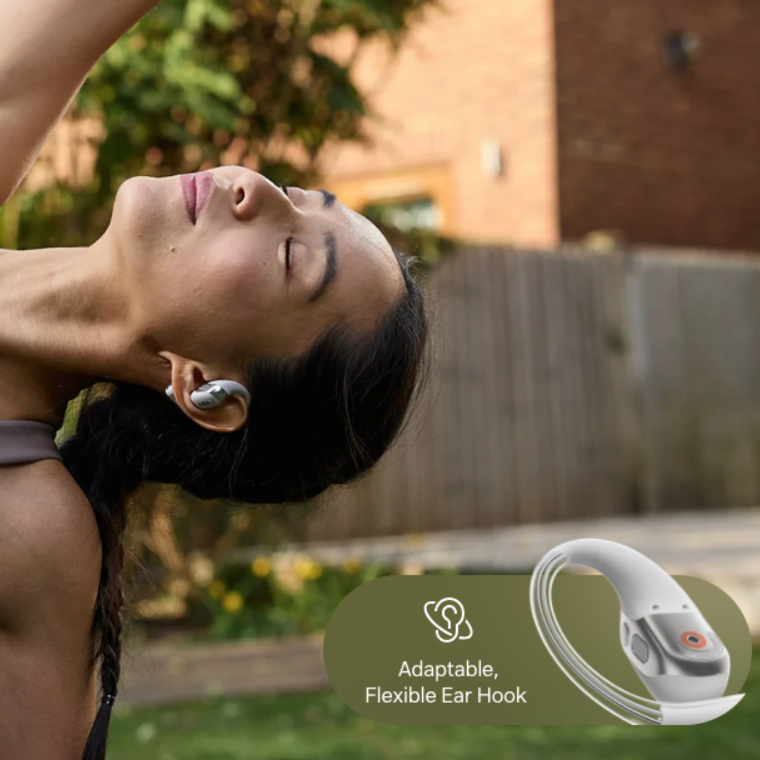 Person wearing Shokz open-ear wireless earbud doing yoga outdoors, highlighting adaptable flexible ear hook design
