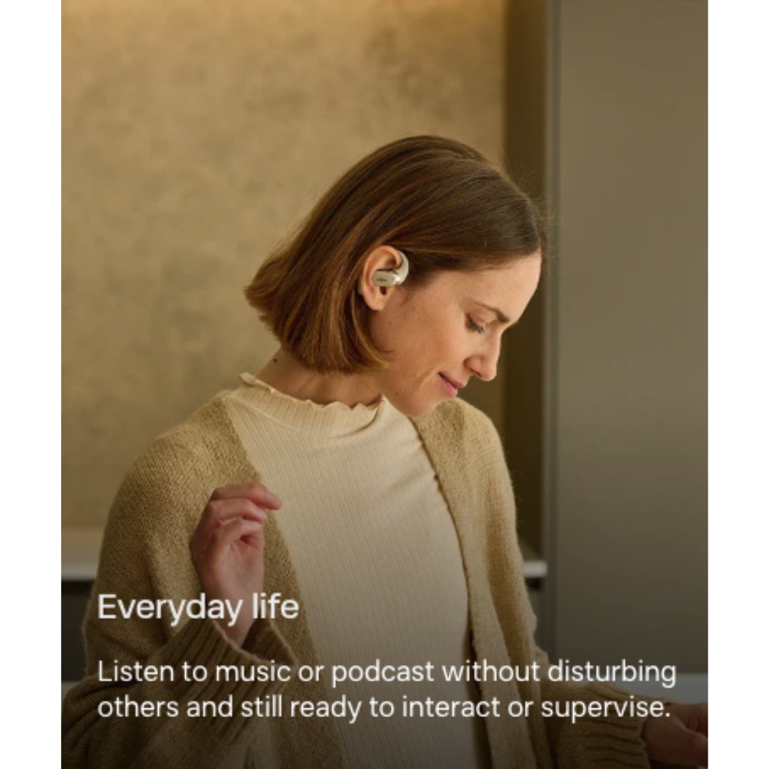 Woman using Shokz open-ear wireless earbuds, listening to music or podcast and ready to interact with others