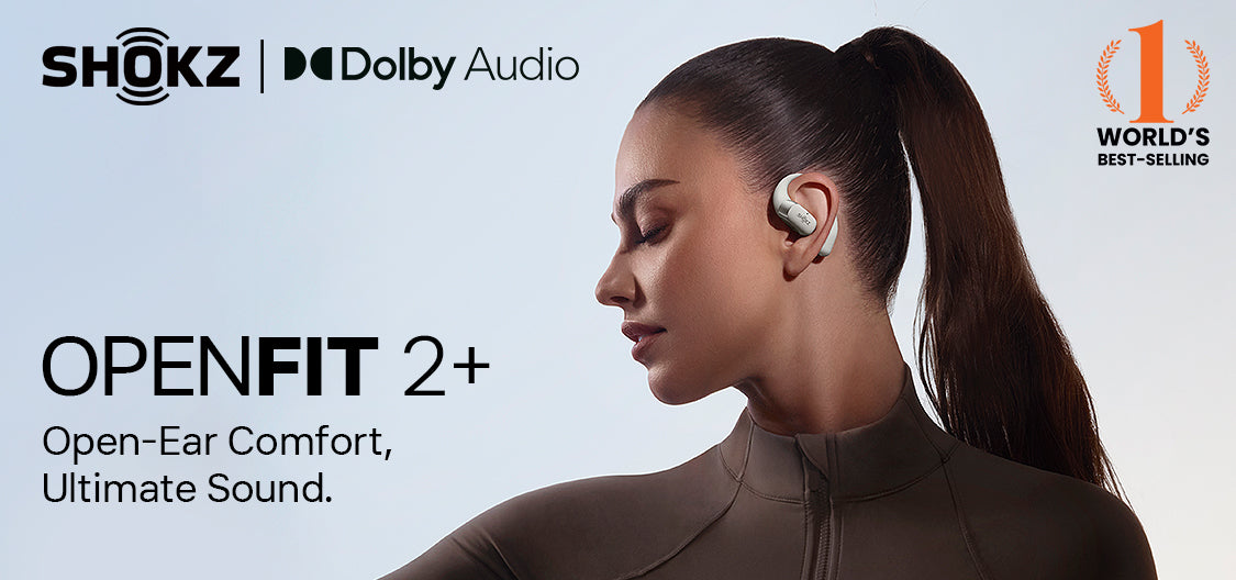 Shokz OpenFit 2 Plus wireless earbuds with Dolby Audio, worn by a woman with a ponytail, promoting open-ear comfort and ultimate sound.