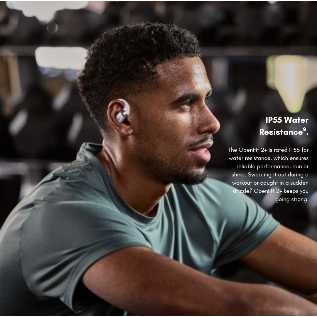 Person wearing Shokz OpenFit 2+ wireless earbuds at the gym, highlighting IP55 water resistance for sweat and rain