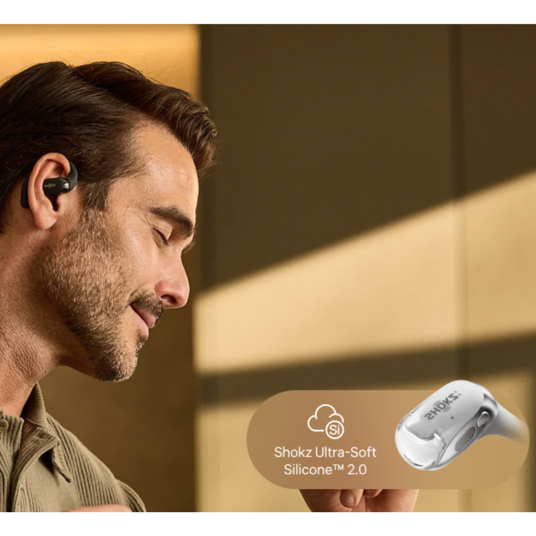Man wearing Shokz open-ear wireless earbud made with Ultra-Soft Silicone 2.0 for comfortable fit