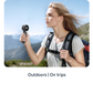 USAMS ZB352 black folding handheld fan used outdoors and on trips, shown with hiker in scenic mountain background