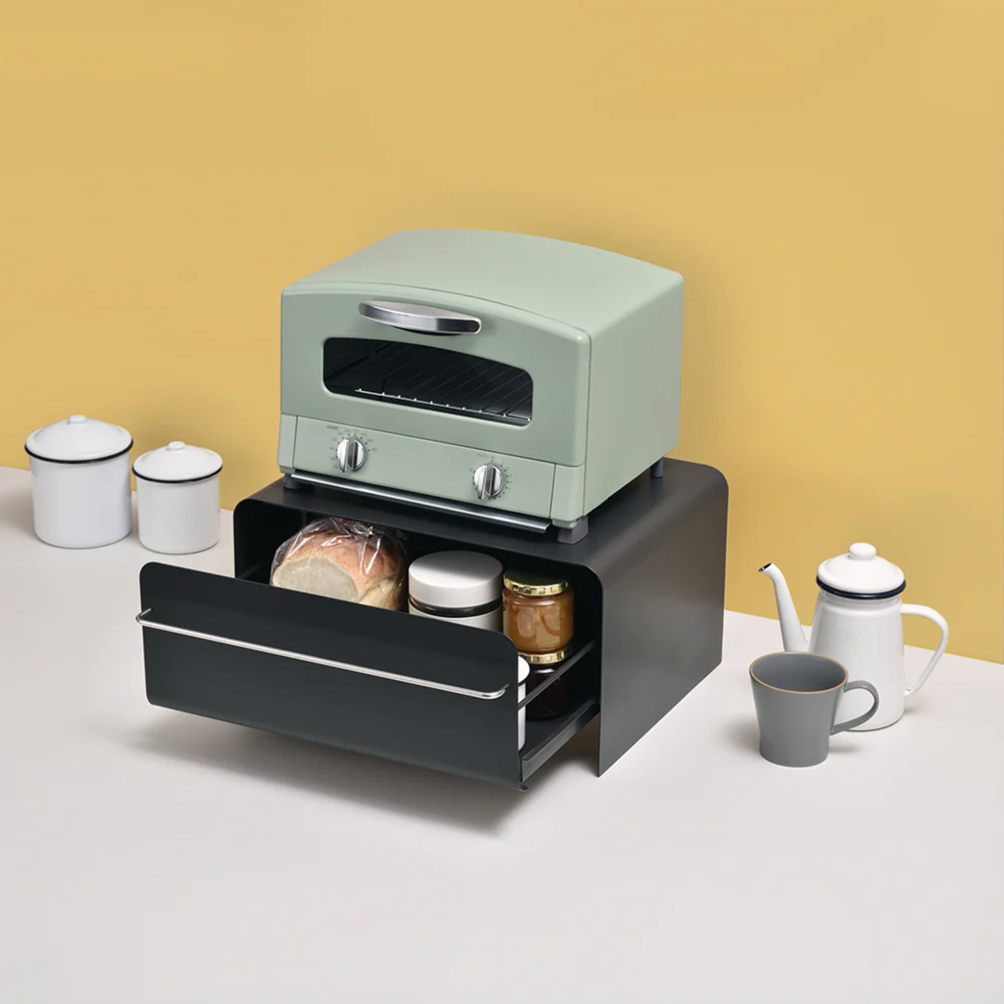 UtaU Bread Drawer in calm grey under retro mint green toaster, open to show neatly stored bread and jars on minimalist breakfast counter.