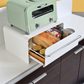 UtaU Bread Drawer in white under retro mint green toaster, open kitchen storage drawer neatly organising bread, snacks and jars on countertop.