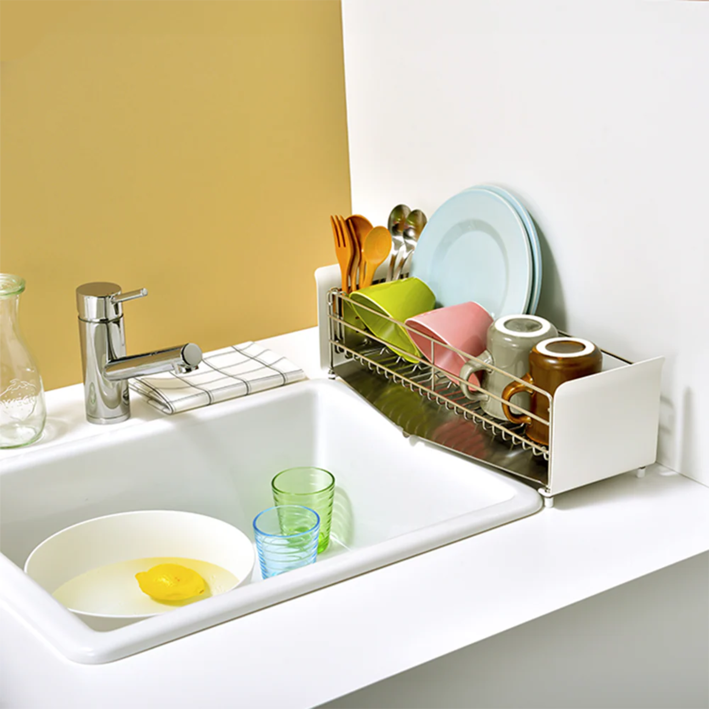 UtaU Dish Drainer Short pure white over-the-sink rack holding plates, mugs and utensils on modern kitchen countertop.