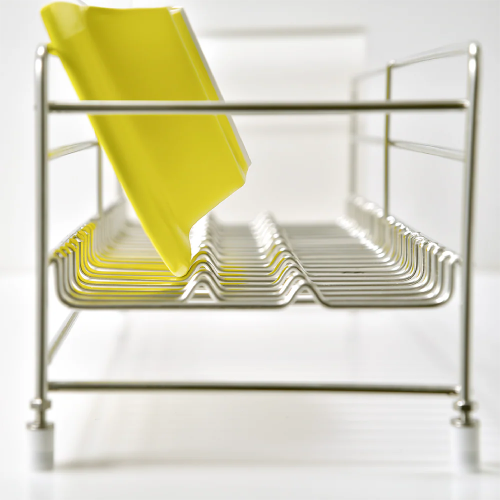 Side view close-up of UtaU Dish Drainer Short showing stainless steel rack and removable yellow drip tray insert