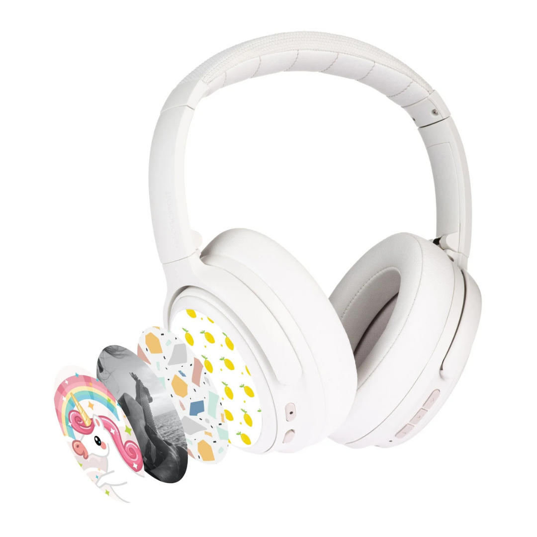 White wireless kids headphones with active noise cancellation, shown with multiple decorative sticker covers including unicorn, geometric, and lemon designs.