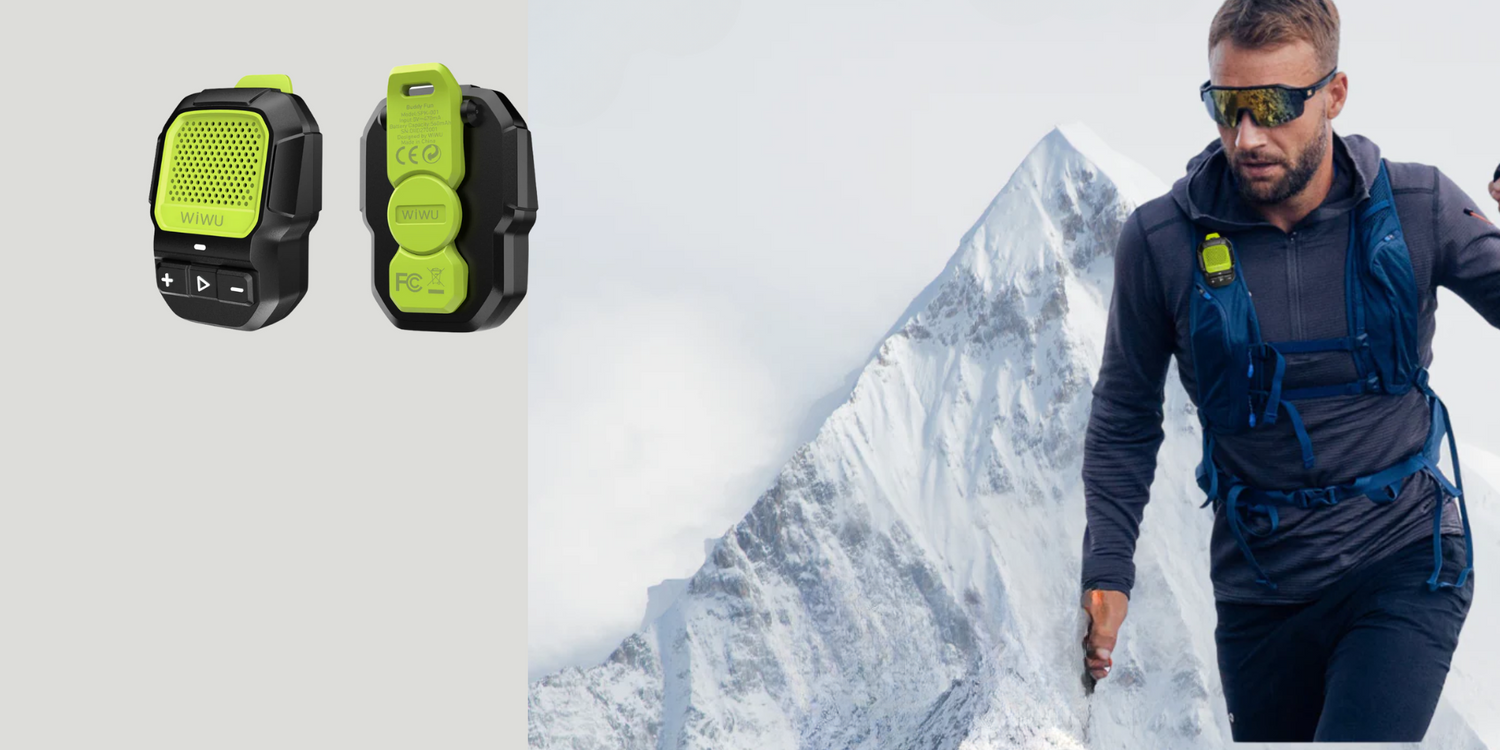 WiWU Buddy Fun Clip-On Speaker in green, shown attached to a hiker’s backpack with a mountain in the background; rugged, portable, and adventure-ready design.