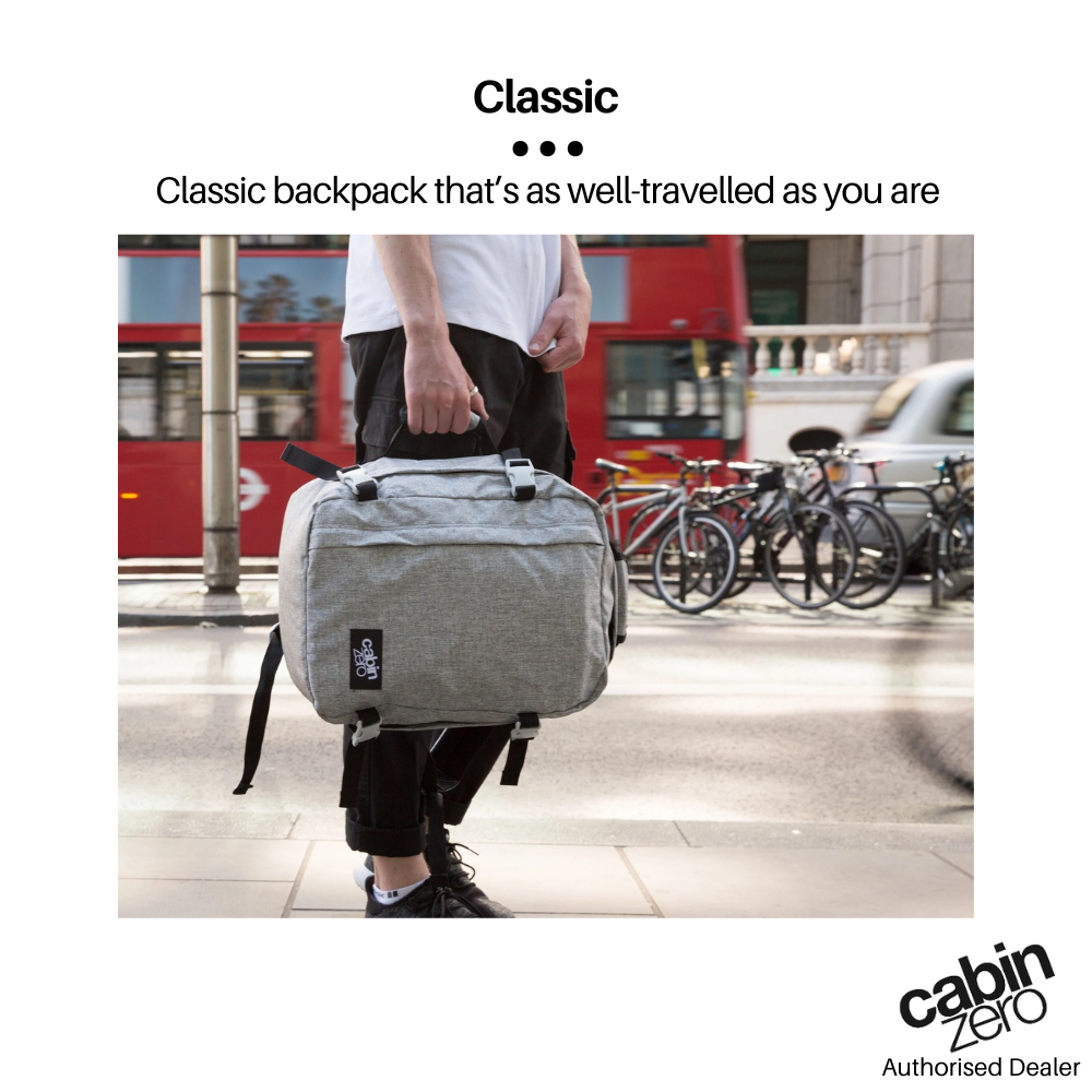 CabinZero Classic Ice Grey 28L backpack carried by a traveler in an urban street setting, featuring heather grey color and practical design, available at ideale lifestyle.