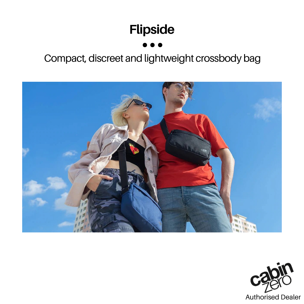 CabinZero Flipside crossbody bags worn by two people outdoors, showcasing compact and lightweight design in black and navy blue.