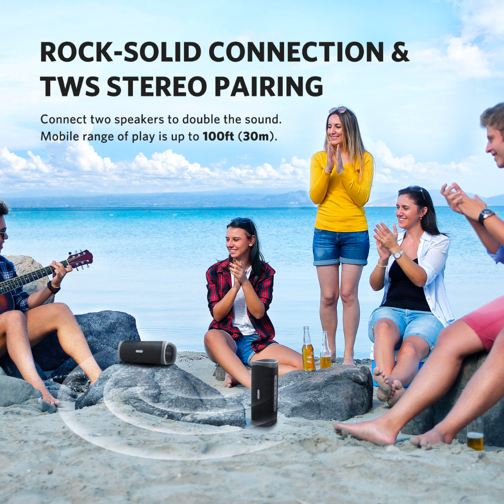 Group of friends enjoying music at the beach with two EarFun UBOOM L speakers paired for TWS stereo sound, showing strong wireless connection and 30m range