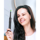 Person holding Fairywill black electric toothbrush in bathroom setting, face blurred for privacy