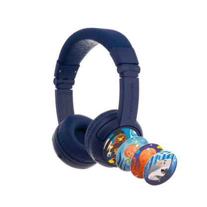 Navy blue over-ear kids’ headphones with a cushioned headband, shown with four interchangeable decorative discs featuring pirate, fish, octopus, and shark ocean-themed illustrations