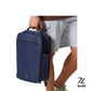 old Quiver 13L navy blue minimalist sports backpack with front zipper pocket, top handle, and compact design, carried by man in casual shorts, ideal for gym, travel, and everyday use